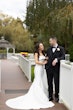 Bride wearing Mitchell Marie by Maggie Sottero standing with her husband