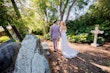 Bride wearing Demetria by Maggie Sottero holding hands and walking with her husband