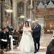 Bride Wearing Glam Long Sleeve Wedding Dress Called Seneca By Sottero And Midgley Walking Down the Aisle With Groom