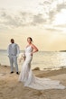 Bride wearing Franklynn by Sottero and Midgley with her husband on the beach