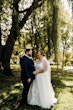 Bride wearing Pia wedding dress by Maggie Sottero laughs with her husband