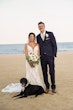 Groom with Dog and Bride at Beach Wedding with Bouquet Wearing Sexy Mermaid Wedding Dress called Tuscany by Maggie Sottero.