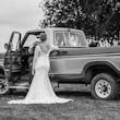 Bride wearing Drita wedding dress by Maggie Sottero in front of a truck