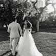 Bride wearing Lettie by Rebecca Ingram walking with her husband