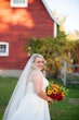 Bride Wearing Flirty A-line Wedding Dress Called Savannah by Maggie Sottero with Bouquet..