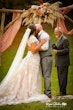 Bride wearing Kingsley wedding gown by Sottero and Midgley kissing her husband during their ceremony