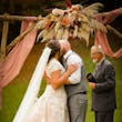 Bride wearing Kingsley wedding gown by Sottero and Midgley kissing her husband during their ceremony