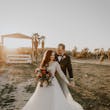 Bride And Groom Standing Together During Sunset. Bride Wearing Beautiful Boho Long Sleeve Ball Gown Called Mallory Dawn By Maggie Sottero
