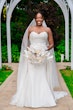 Bride Wearing Simple Fit and Flare Wedding Dress Called Anniston Lane With A White Bouquet