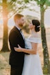 Bride Wearing Off-The-Shoulder A-Line Wedding Dress Called Coral By Rebecca Ingram With Groom