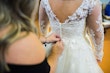 Bride Wearing Long Sleeve Ball Gown Wedding Dress With A Tiered Organza Skirt Tessa By Rebecca Ingram