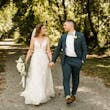 Bride with groom wearing affordable floral ballgown wedding dress.
