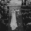 Bride with groom wearing A-line long sleeve lace wedding dress.