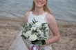 Bride wearing Davis Leigh wedding dress by Sottero and Midgley holding her bouquet