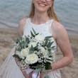 Bride wearing Davis Leigh wedding dress by Sottero and Midgley holding her bouquet