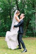 Groom with bride wearing simple crepe wedding dress Bertina by Maggie Sottero.