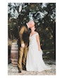 Bride wearing Darius wedding dress by Maggie Sottero kissing her husband