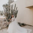 Bride Showing Off Long Tulle Train. Bride Wearing Romantic Long Sleeve Ball Gown Called Mallory Dawn By Maggie Sottero