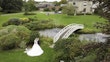 Bride In Lace A-Line Wedding Dress Called Taylor By Maggie Sottero With Long Veil And Groom