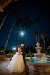 Bride Wearing Sparkly Princess Wedding Dress Called Elton By Sottero And Midgley With Groom Next To A Fountain