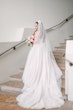 Bride In White Wedding Dress Named Shasta By Sottero and Midgley With Veil And Pink Flowers