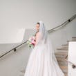 Bride In White Wedding Dress Named Shasta By Sottero and Midgley With Veil And Pink Flowers