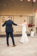 Bride Wearing Glamorous Lace And Sequin Wedding Dress Called Tuscany By Maggie Sottero Dancing With Groom