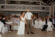 Bride Wearing Crepe Wedding Dress Called Dionne By Rebecca Ingram Holding Hands With Groom At The Reception