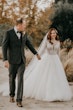 Groom And Bride Walking Together. Bride Wearing Lace Ball Gown Called Mallory Dawn By Maggie Sottero