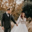 Groom And Bride Walking Together. Bride Wearing Lace Ball Gown Called Mallory Dawn By Maggie Sottero