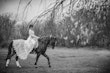 Bride wearing Drita wedding dress by Maggie Sottero riding a horse