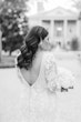 Black And White Image Of Bride Wearing Long Sleeve Lace Wedding Dress Called Cruz By Sotero And Midgley