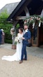 Newlyweds stood together outside their wedding venue.