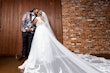 Bride Wearing Chic Crepe Wedding Gown Called Anson By Sottero And Midgley With A Veil Kissing The Groom