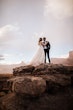 Groom With Bride Wearing A White A Line Wedding Dress Named Keisha By Maggie Sottero On Red Rocks In Desert