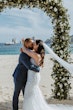 Groom On Beach Kissing Bride In A White Beaded Wedding Dress Named Jonah Lane By Sottero And Midgley