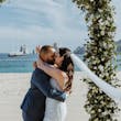 Groom On Beach Kissing Bride In A White Beaded Wedding Dress Named Jonah Lane By Sottero And Midgley