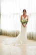 Bride Holding Bouquet Wearing Sexy Mermaid Boho Wedding Dress Called Tuscany by Maggie Sottero.