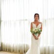 Bride Holding Bouquet Wearing Sexy Mermaid Boho Wedding Dress Called Tuscany by Maggie Sottero.