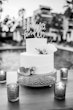 Simple wedding cake with tea lights around it.