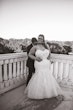 Bride wearing Danielle by Maggie Sottero with her husband on a balcony