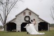 Bride In Off The Shoulder Lace Wedding Dress Called Tiffany By Maggie Sottero With Groom And Cowboy Boots