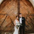Bride with groom in romantic lace sheath wedding dress