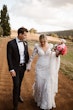 Groom Holding Hands with Bride in VIntage Inspired Puff Sleeve Mermaid Wedding Dress in 3-D Floral Motifs Called Cruz by Sottero & Midgley