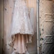 White Wedding Dress Named Johanna By Maggie Sottero Hanging On A Hanger