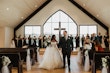 Bride Wearing Sparkly Ballgown Wedding Dress Called Zartasha By Sottero and Midgley Leaving The Church After The Ceremony