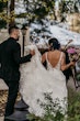 Bride Wearing Lace Ballgown Wedding Dress Called Sasha By Maggie Sottero Walking While Groom Caring The Train