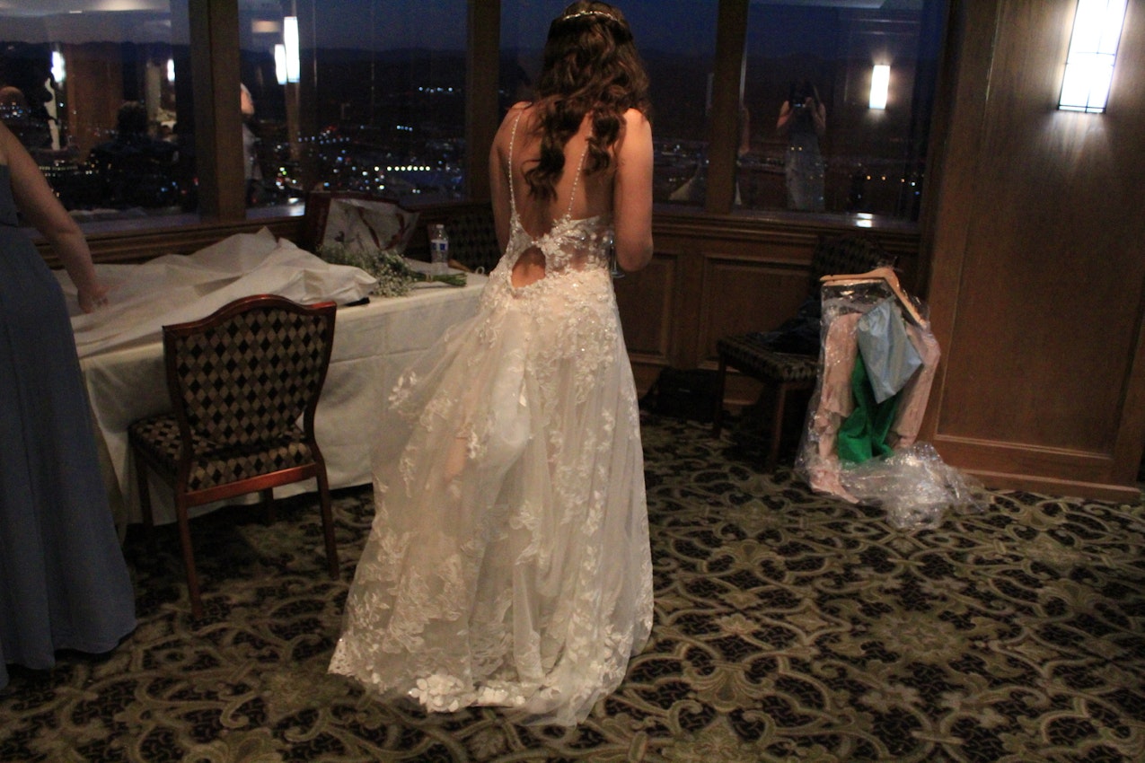 Bride's dress called Marlow with her train bustled for the night party.