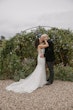 Bride wearing Luella wedding dress by Sottero and Midgley kissing her husband