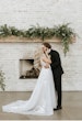 Groom Kissing Bride Wearing Plunging Lace Illusion Wedding Dress Called Raelynn By Rebecca Ingram